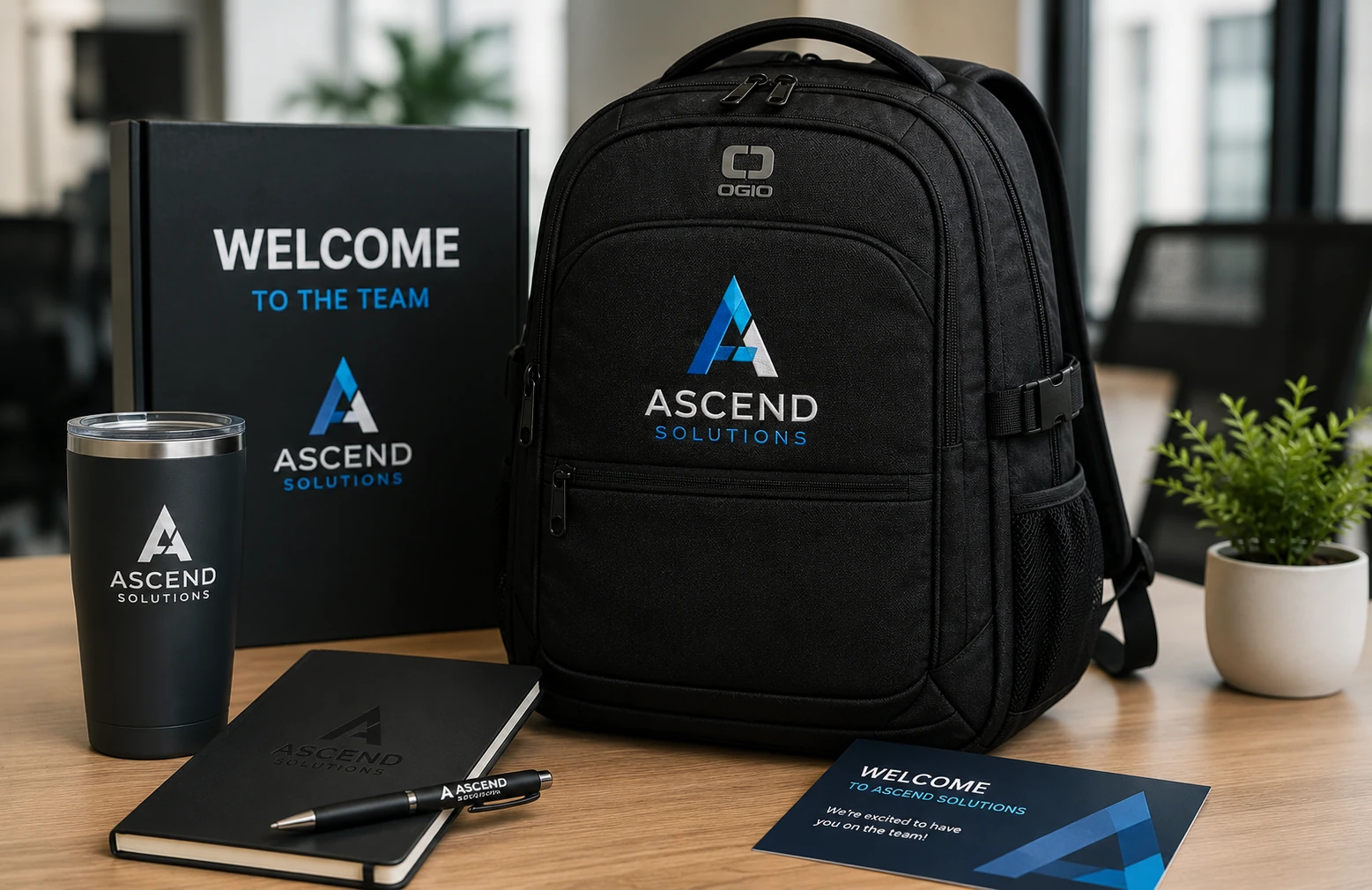 Branded OGIO backpack anchoring a corporate onboarding welcome kit on an office desk