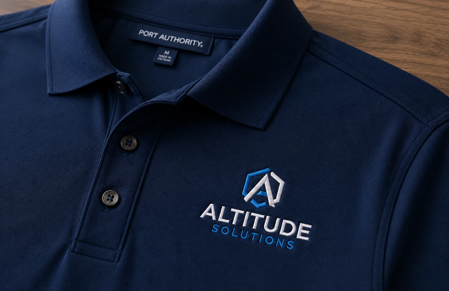 Embroidered left-chest company logo on a navy Port Authority pique polo